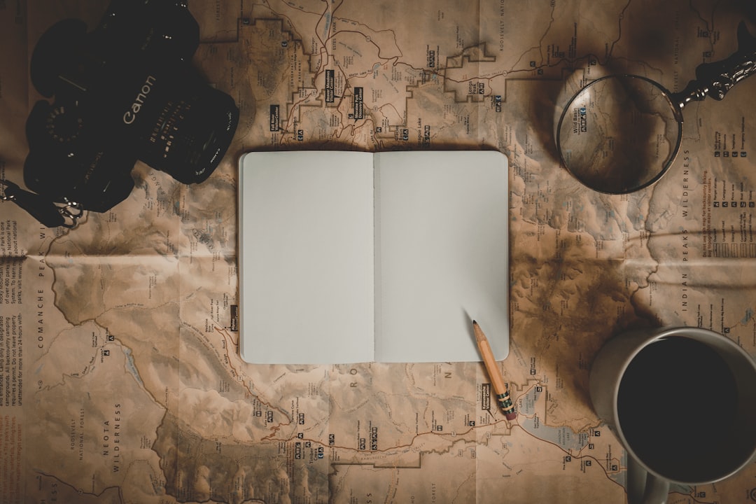 Open notebook and coffee on a table, travel journaling