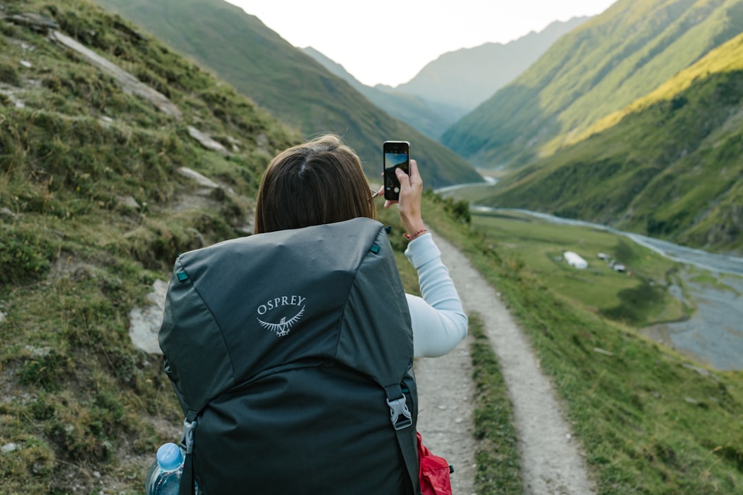 Person vlogging with smartphone on a tripod while traveling