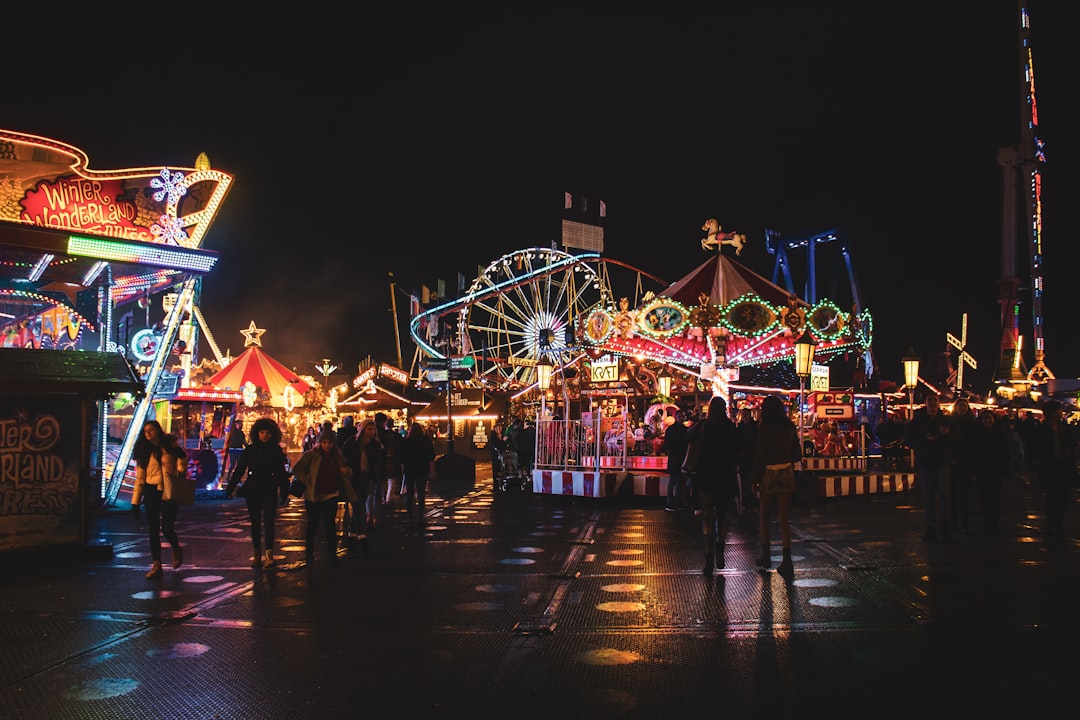 Carnival midway rides lit up at night