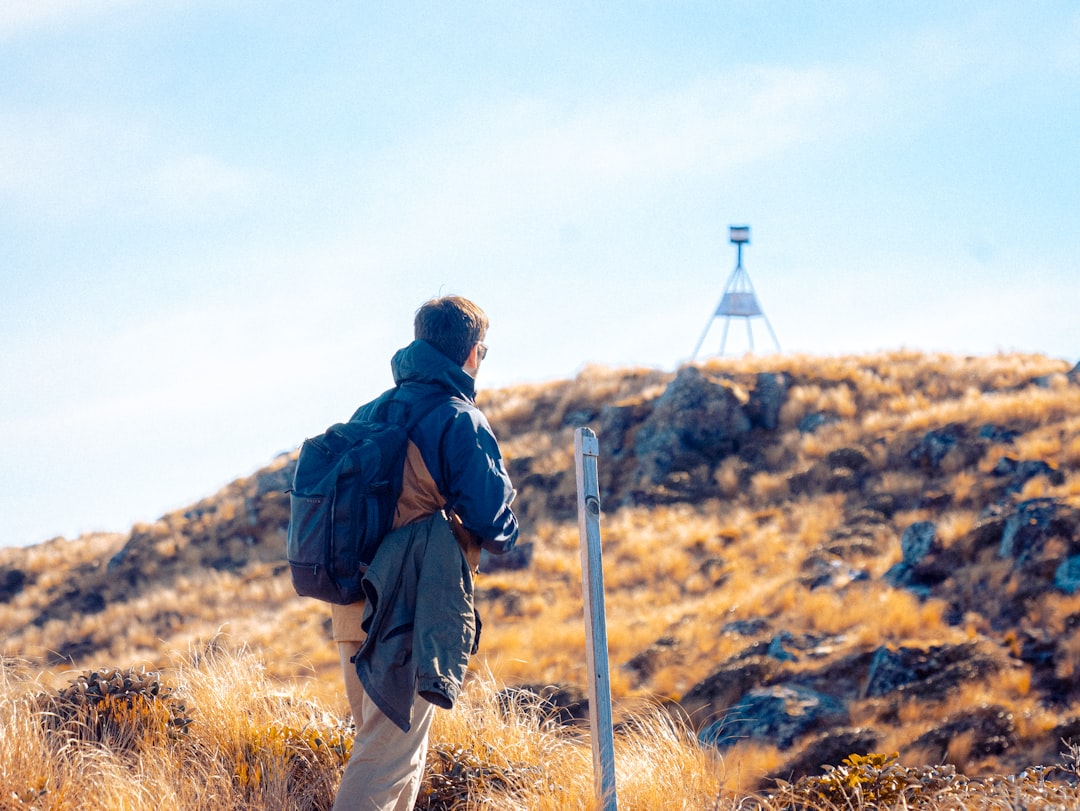 Backpacker enjoying panoramic views from a mountain summit in Idaho