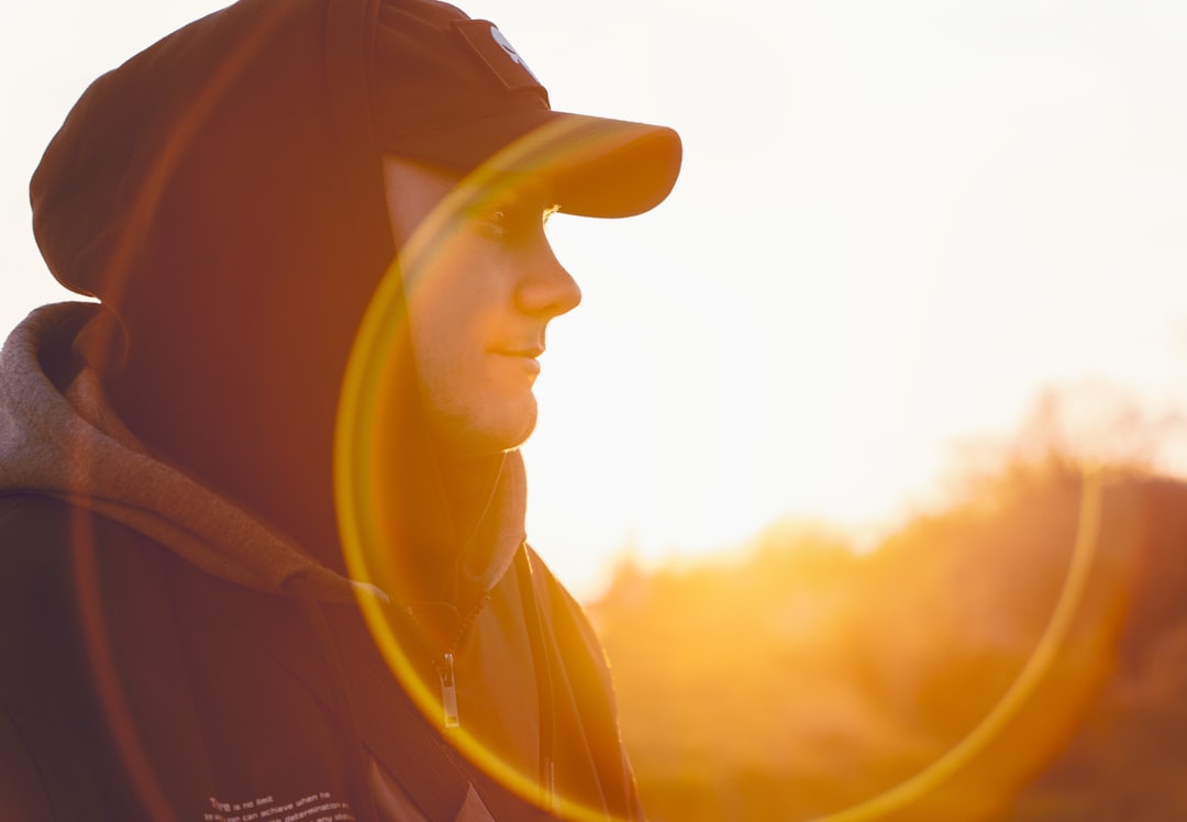 Hiker wearing a UPF sun hoodie on an exposed desert trail