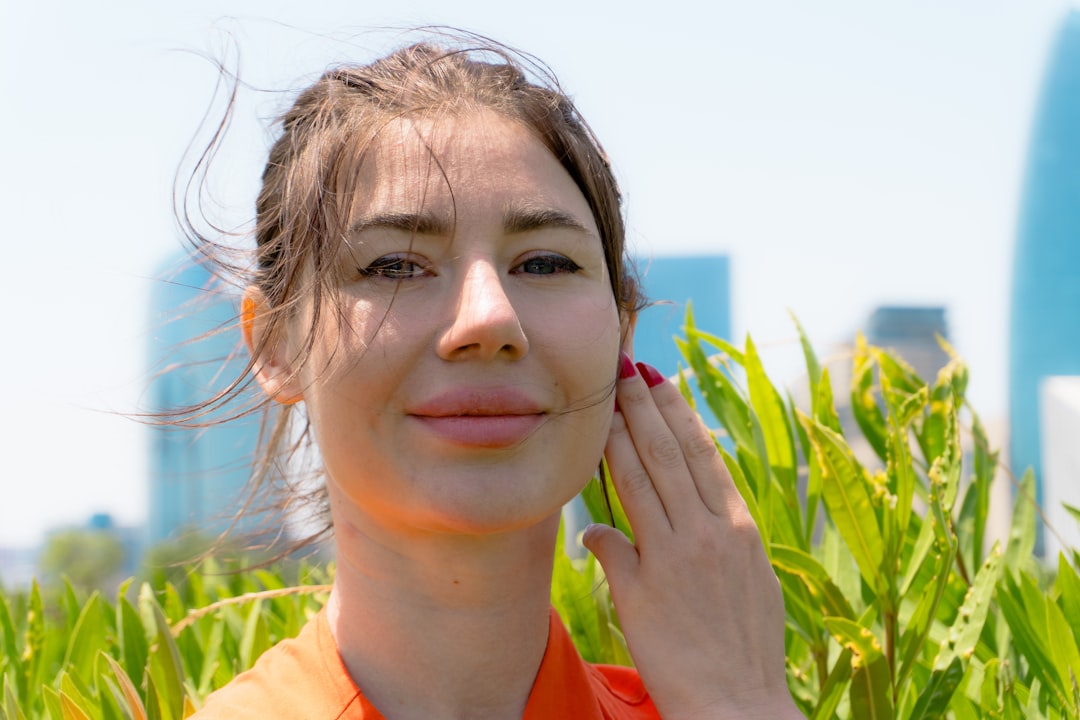 Woman reapplying sunscreen outdoors