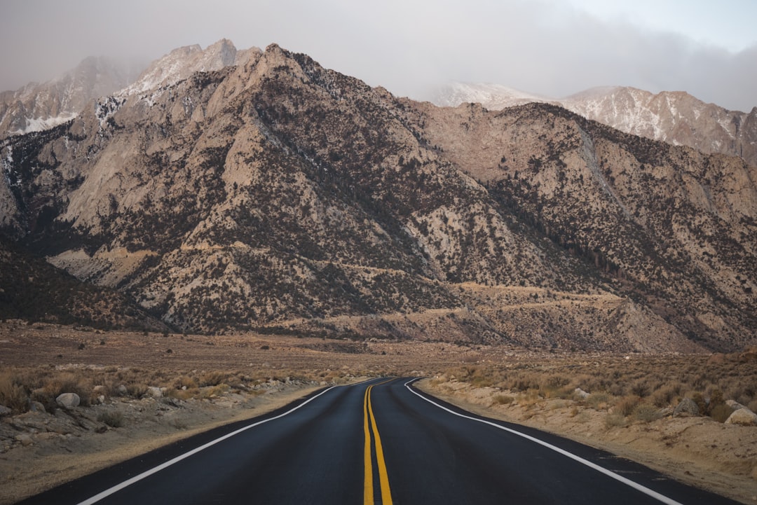 Scenic mountain highway winding through volcanic peaks and pine forest