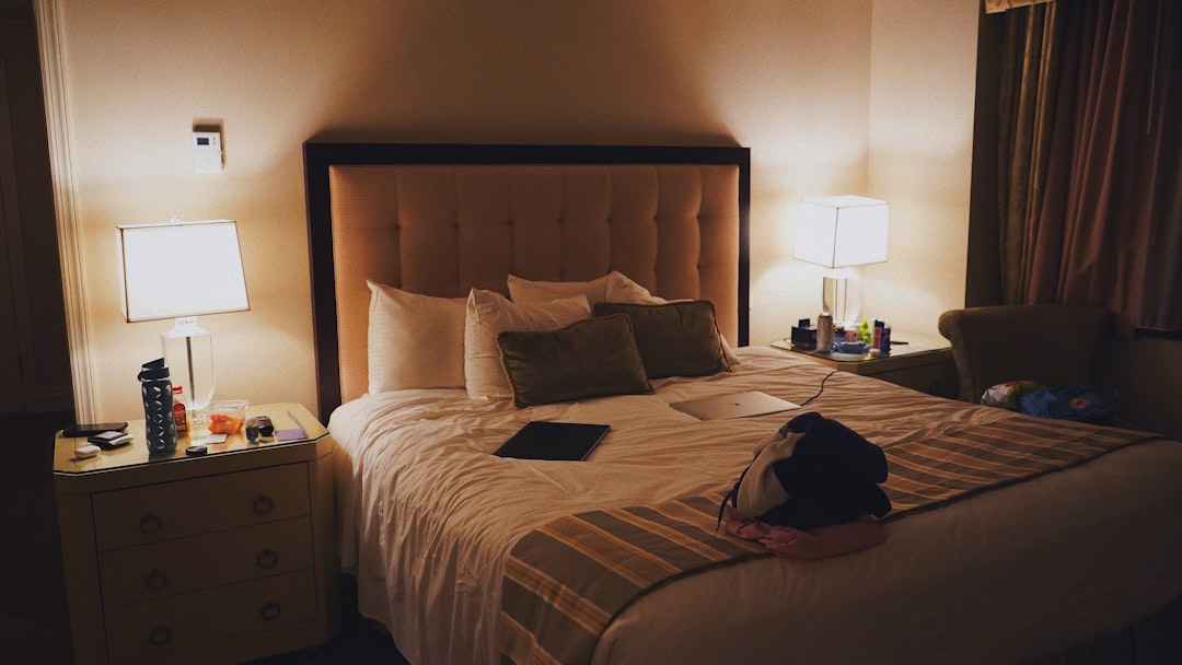 Traveler organizing and packing a backpack in a hotel room