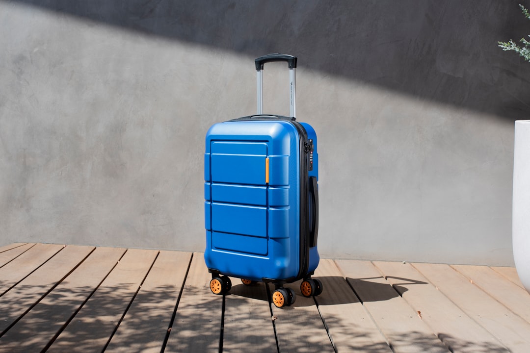 A hard-shell suitcase standing in an airport