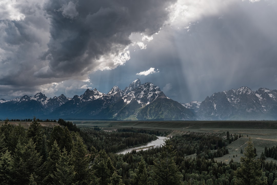 The Snake River winding toward the Teton Range under dramatic skies