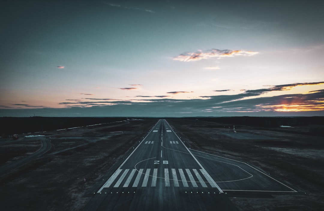 Airplane on the runway at sunrise after a red-eye flight