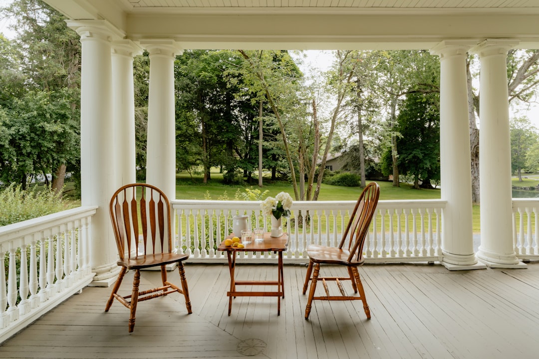 Historic Victorian hotel porch with rocking chairs overlooking the water
