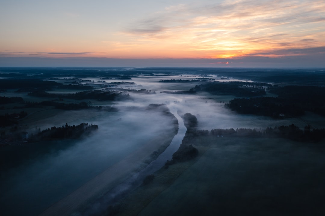 Mist drifting through a river valley at dawn