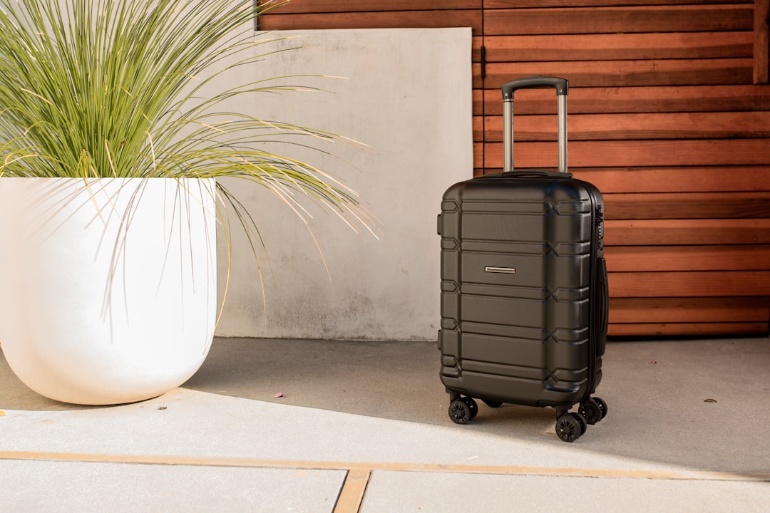 Suitcase rolling down a cobblestone street in an old city