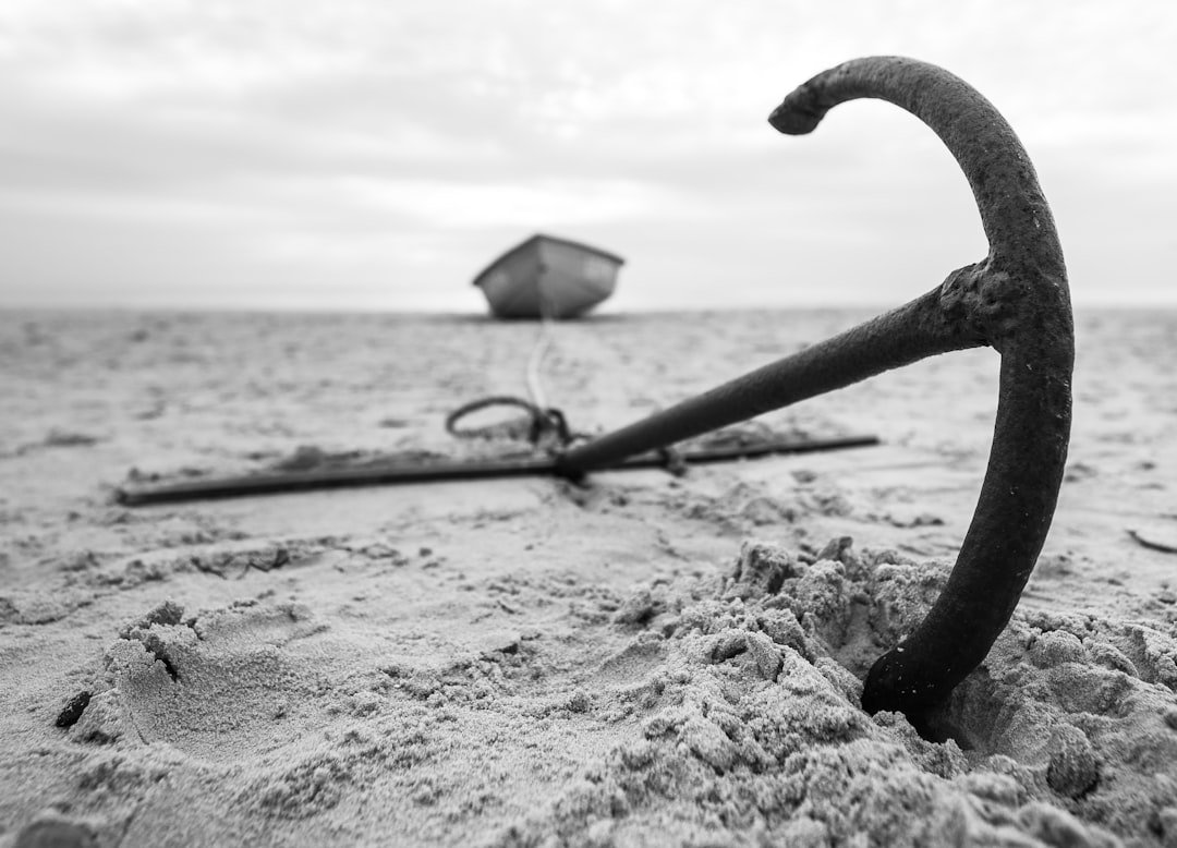 Boat anchored near tropical beach with clear turquoise water
