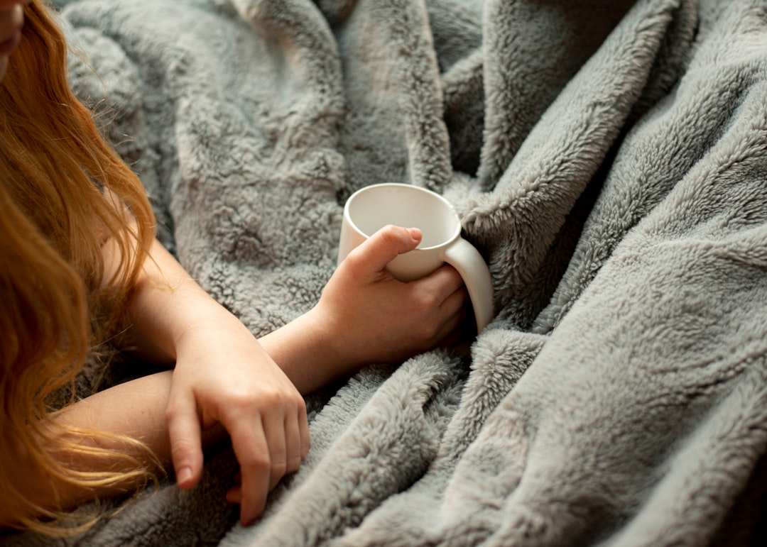 Traveler wrapped in a warm blanket settling in for sleep