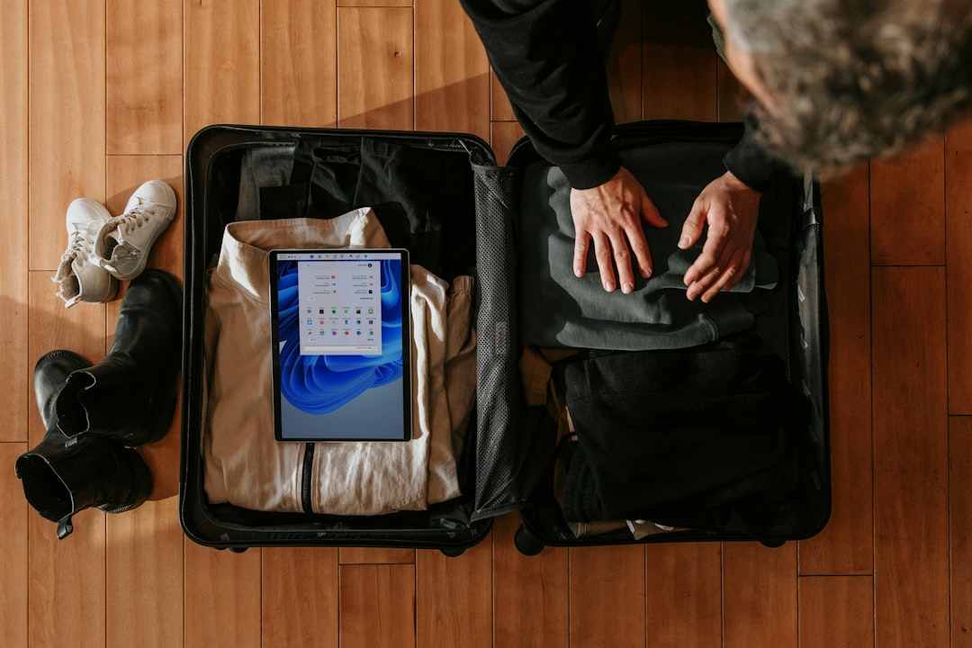 Packing a suitcase for a formal event on a wooden floor