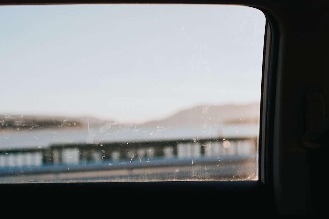 Frost creeping across a vehicle window on a cold morning