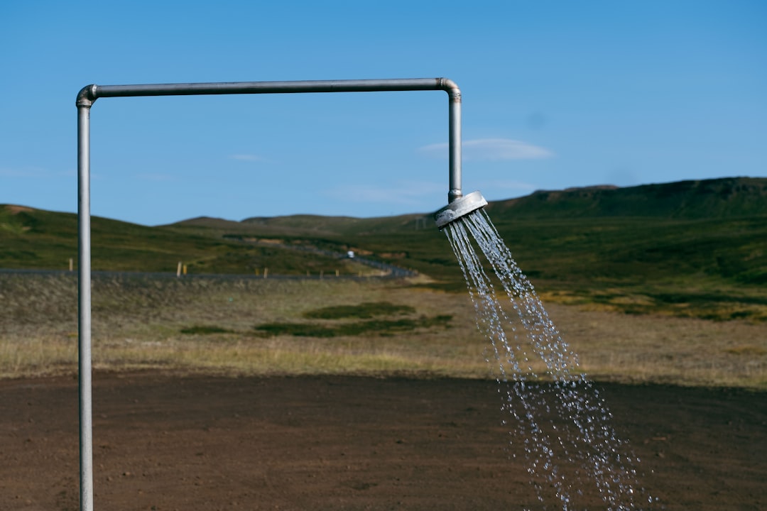 Outdoor shower setup at a rural campervan campsite