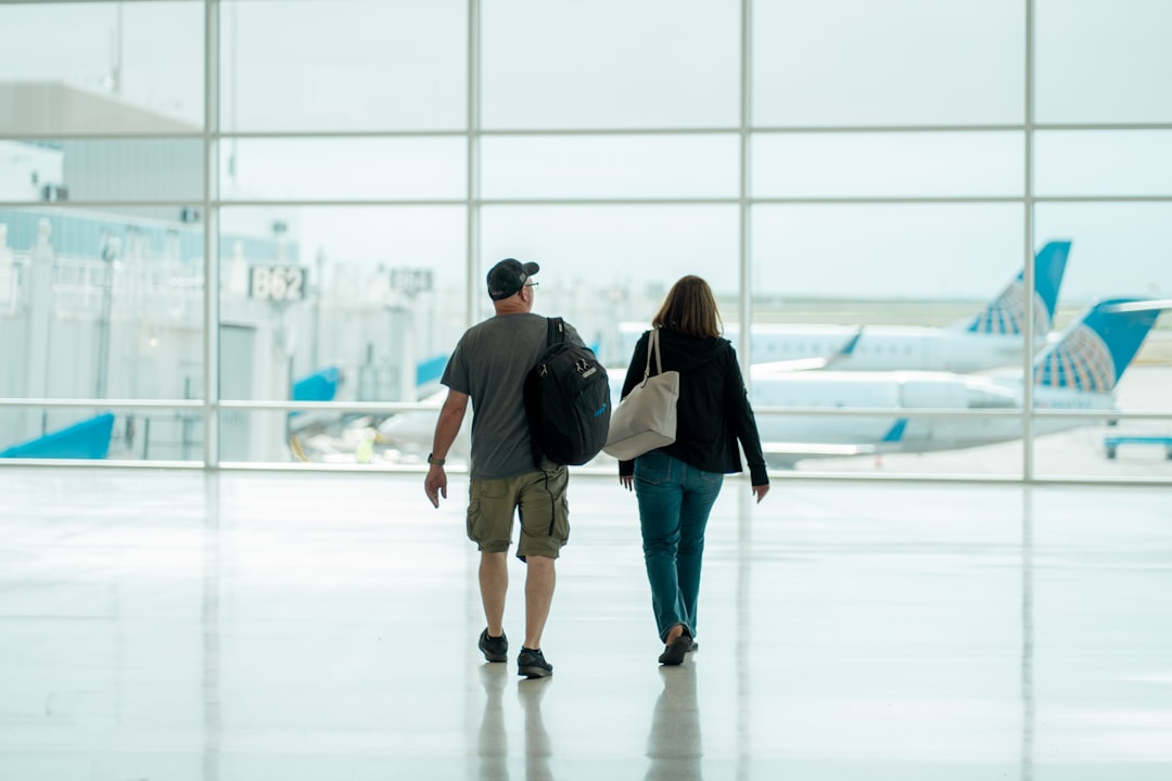 Travelers walking through an airport terminal toward their gate