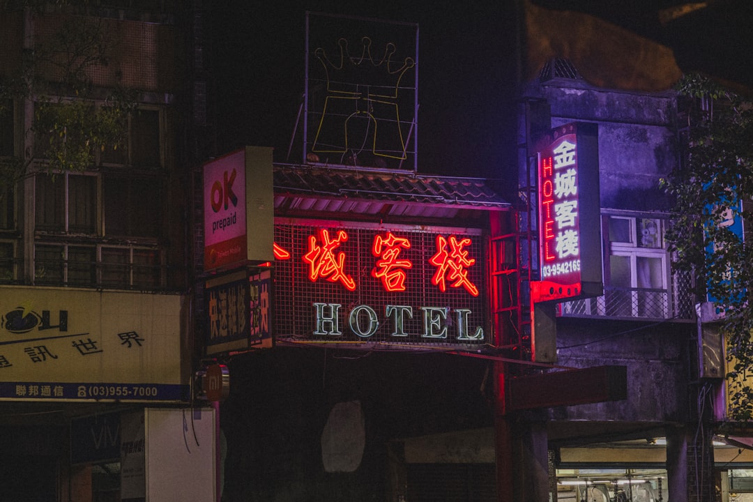 A glowing vintage neon motel sign against the night sky