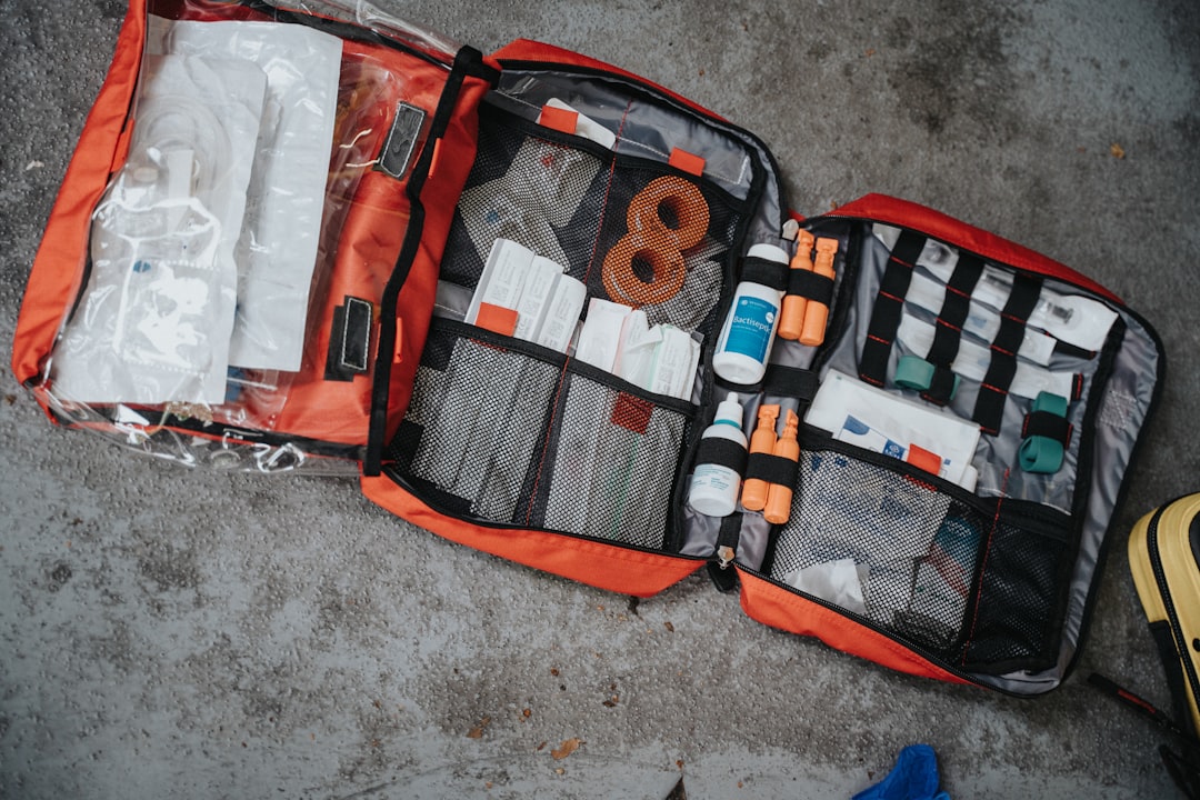 An open first aid kit with bandages and medical supplies laid out