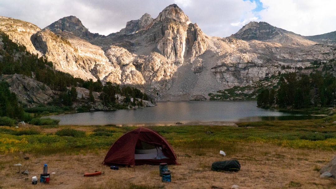 Tent campsite beside a mountain-ringed lake