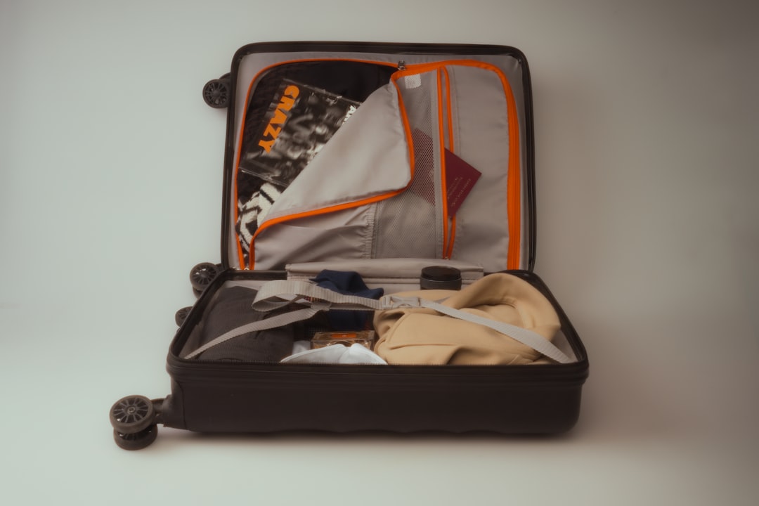 Open suitcase with folded clothes and travel essentials
