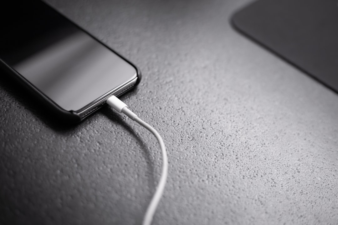 Phone charging cable clutter on a desk