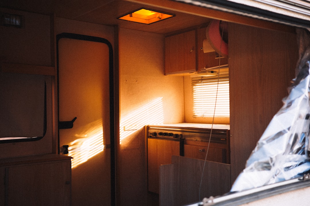 Cozy campervan interior lit warmly at night with bedding and blankets