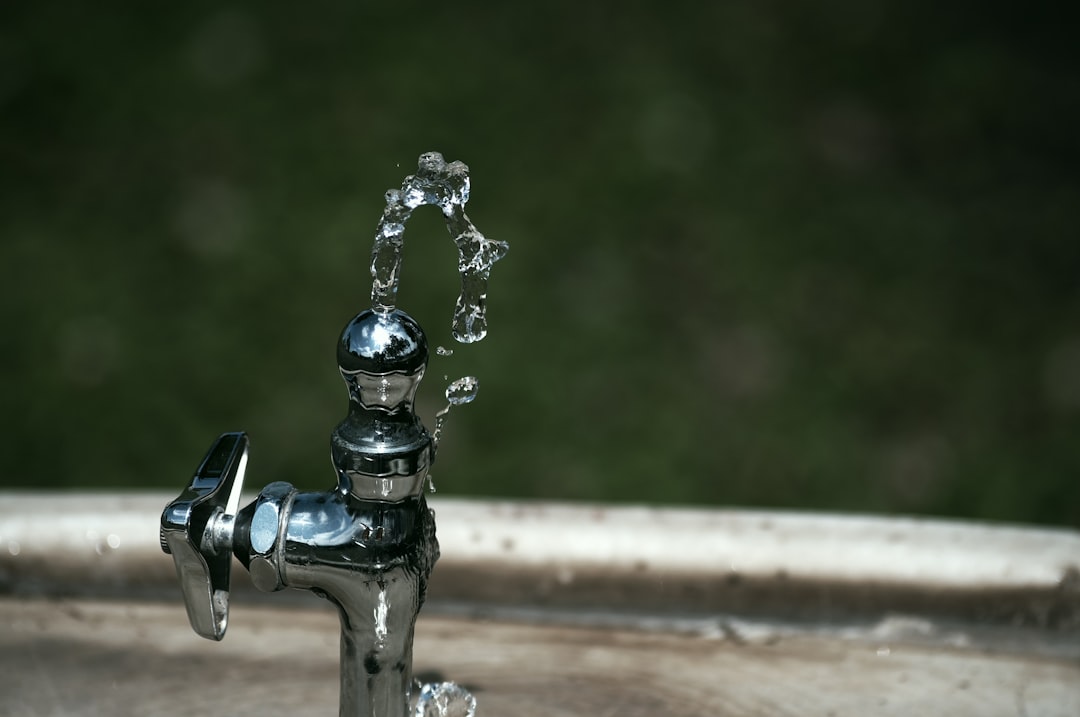 Water streaming from a chrome faucet