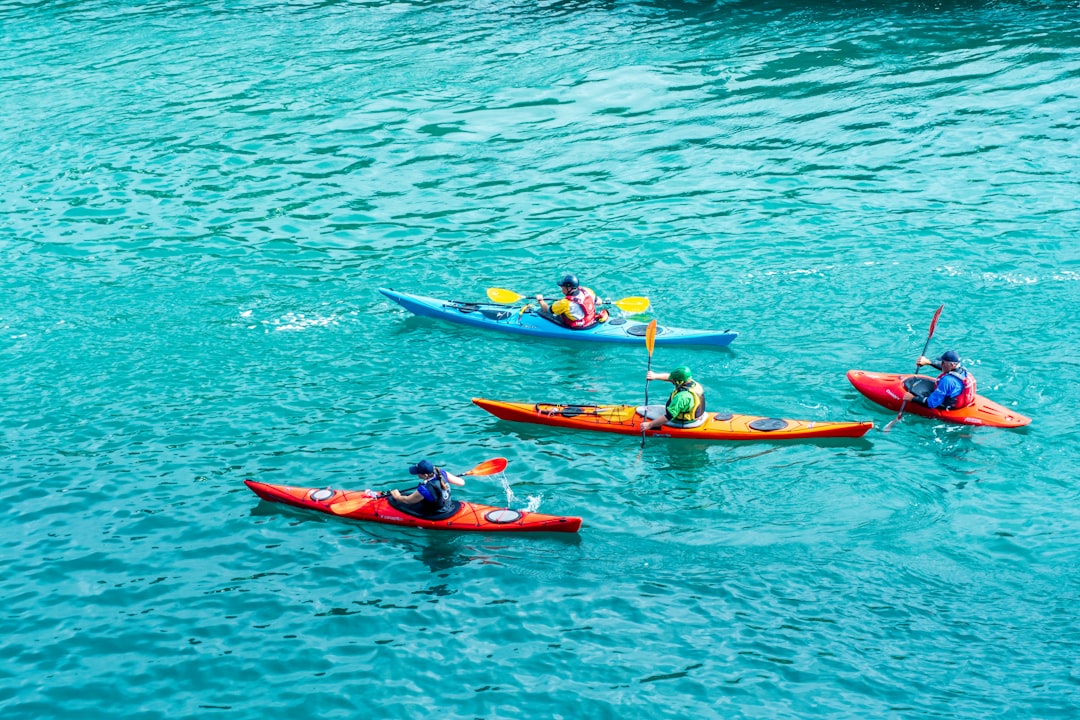 Paddler in a kayak gliding over turquoise tropical water