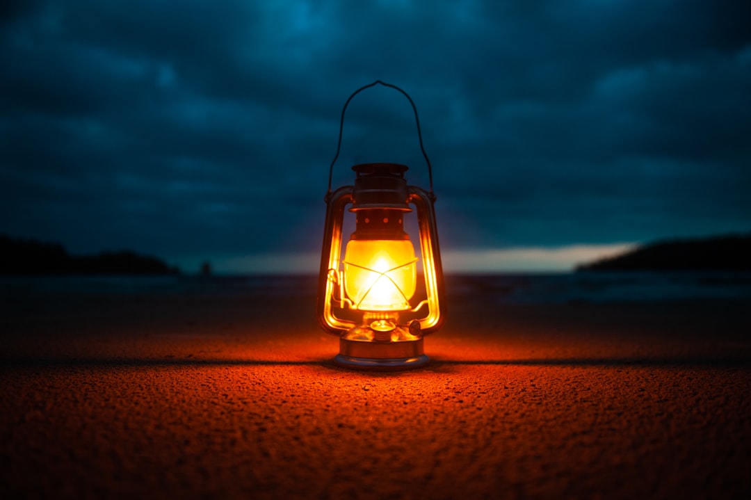 Camping lantern glowing inside a tent at night
