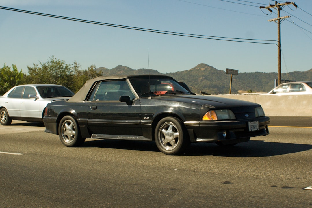 A classic convertible cruising down an open highway on a road trip