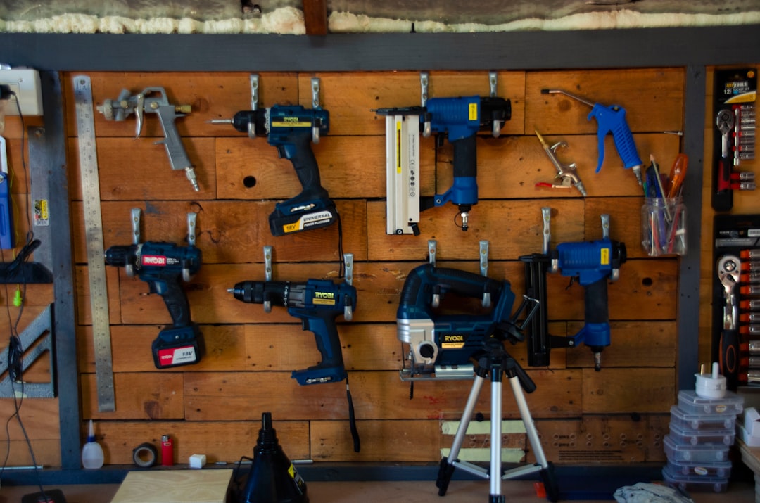 Cordless drill and hand tools laid out for a van build project
