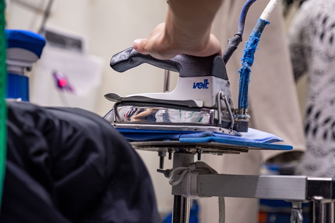 Hand pressing a garment with a steam iron