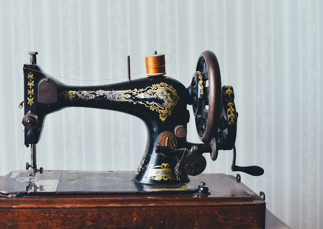 Vintage sewing machine on a wooden table ready for canvas work
