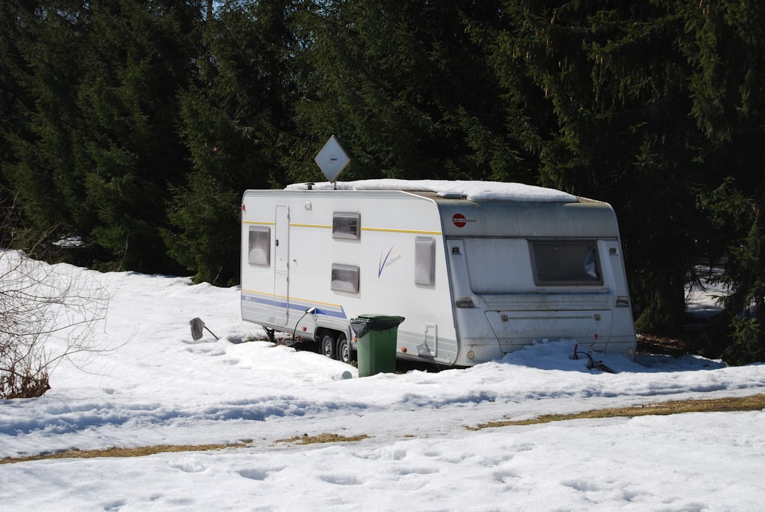 Campervan parked in deep snow during winter camping trip