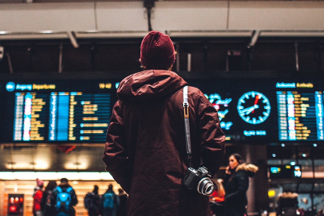 Traveler checking flight boards in an airport terminal