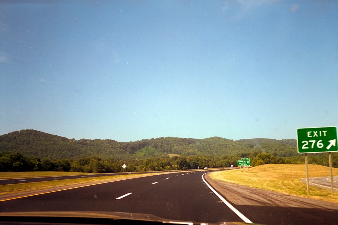 Open road through scenic summer landscape on a road trip