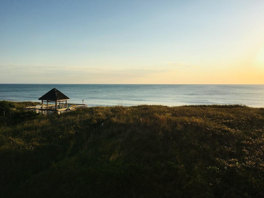Beach camping tent at sunrise near ocean
