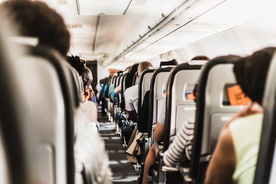 Passengers settled into an airplane cabin with bags stowed