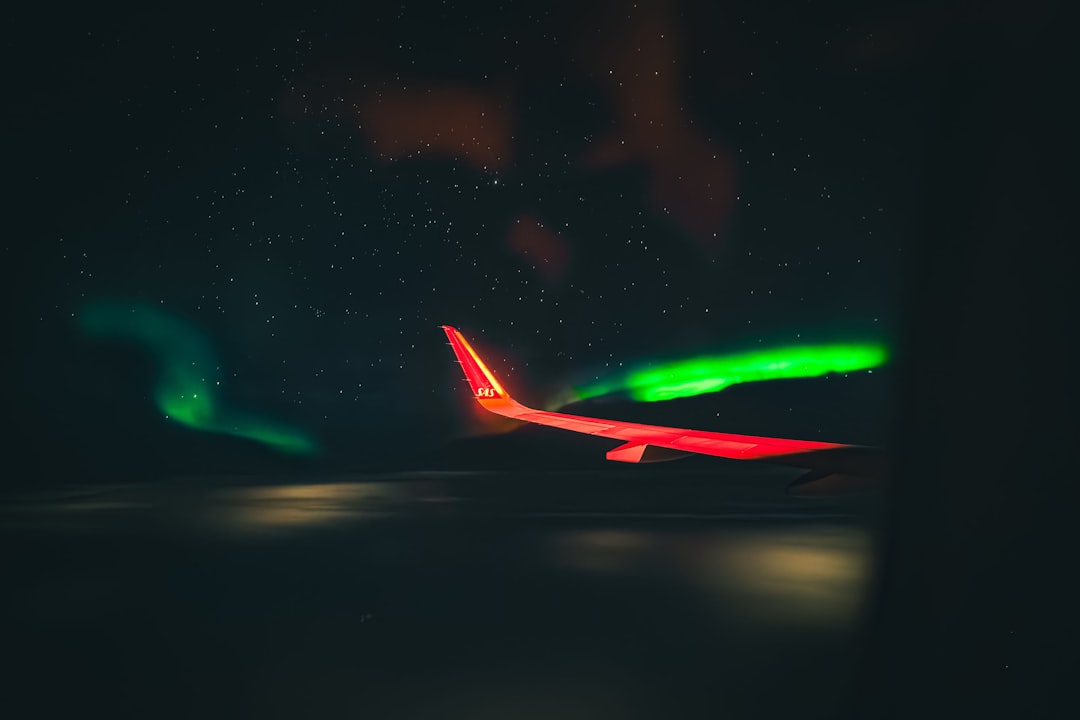 Airplane wing against a starry night sky