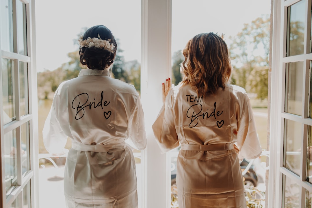 Bride and bridal party in robes getting ready by a window