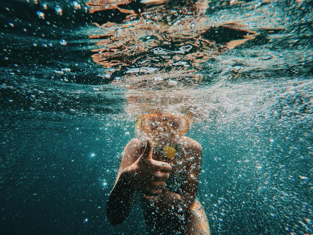 Snorkeler giving thumbs up underwater