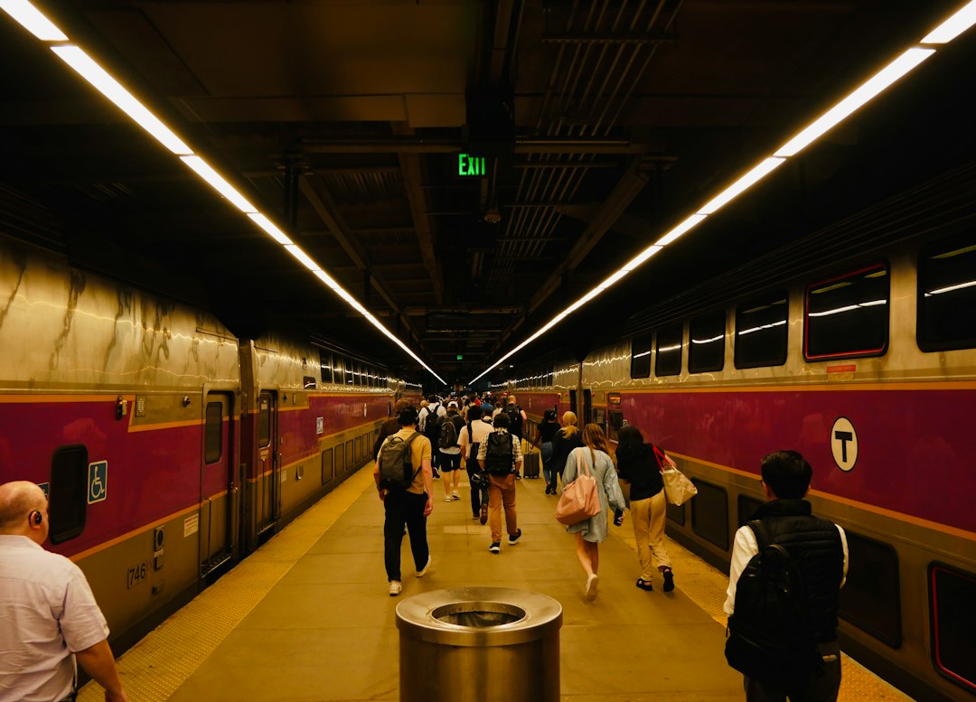 MBTA commuter rail train arriving at a station platform near Boston