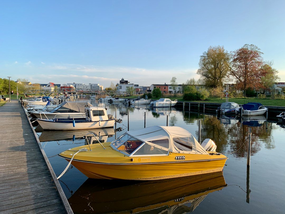 Small boats docked at a neighborhood marina pier