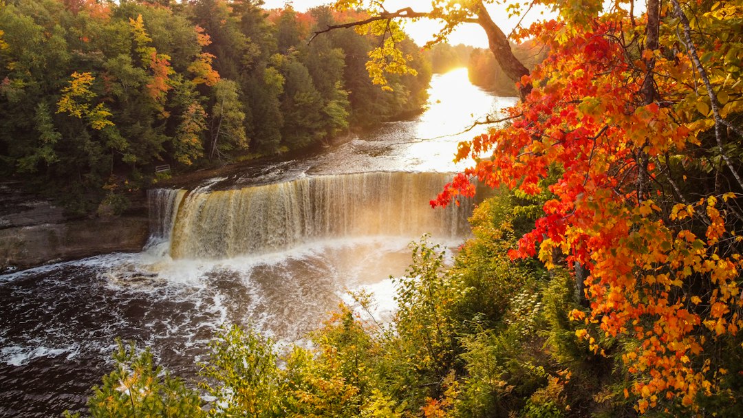 Autumn waterfall cascading through forest rock ledges