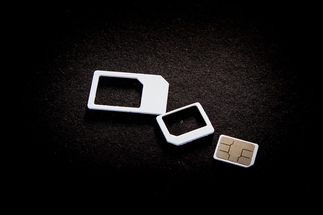 MicroSD memory card held near a camera before insertion