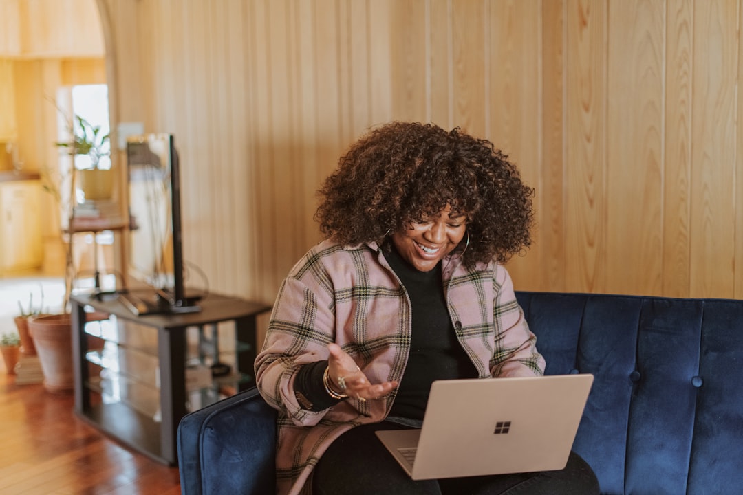 Woman comparing prices on a laptop from her couch