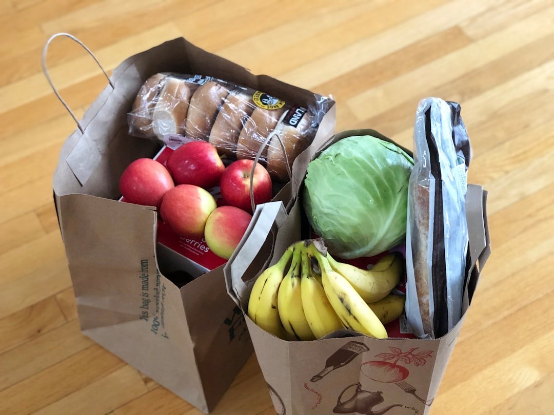 Reusable tote bags filled with fresh groceries and produce