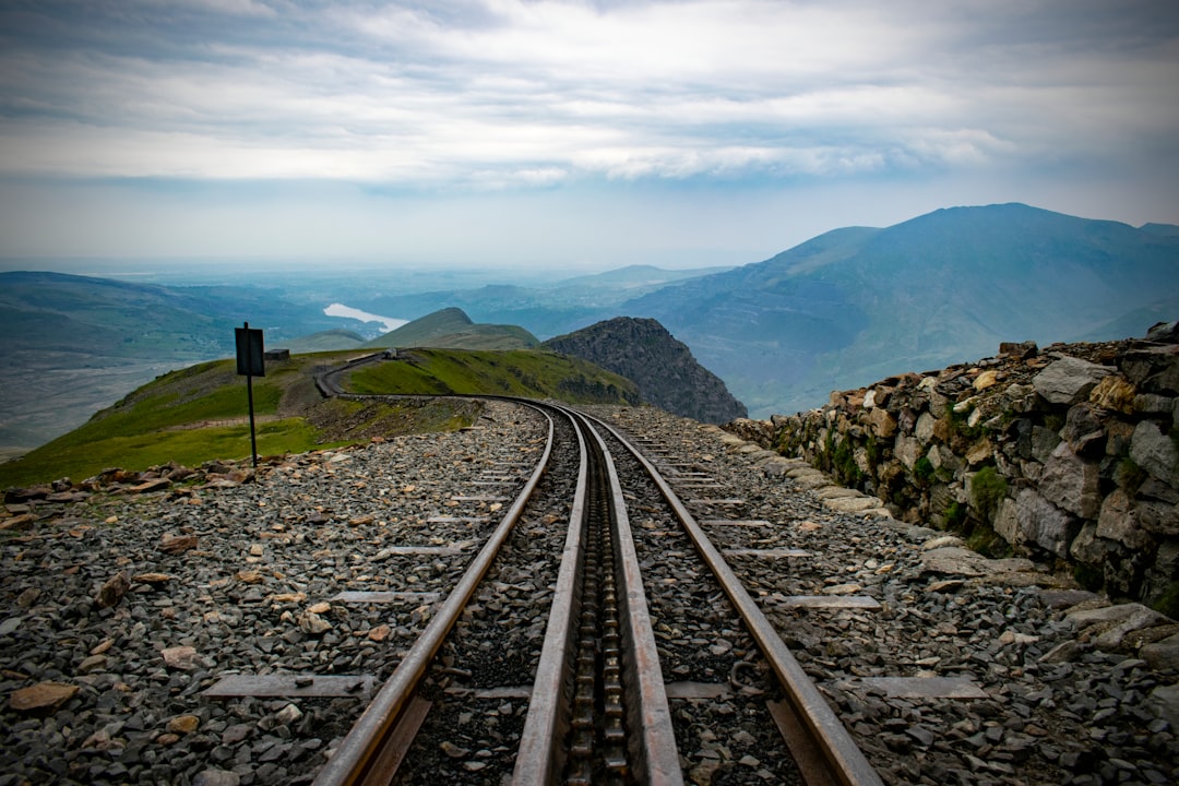 Steep cog railway tracks climbing a rocky mountain slope above the tree line