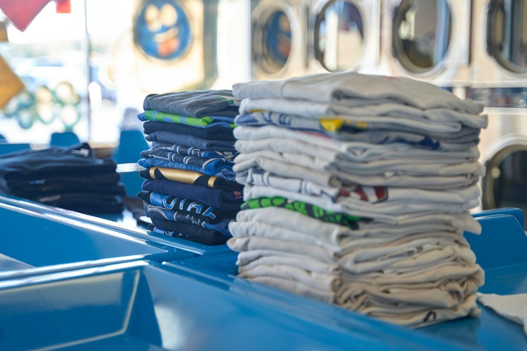Neatly folded clothing stacks organized for cruise packing
