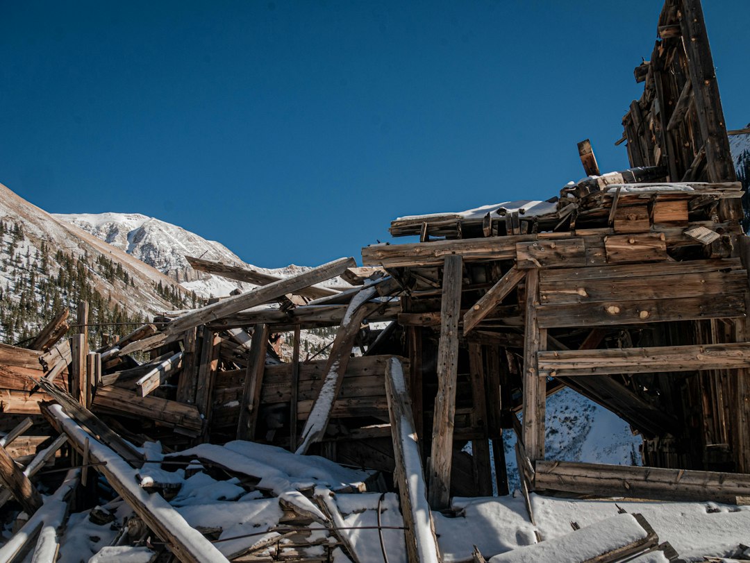 Abandoned mine buildings and headframes against desert mountains